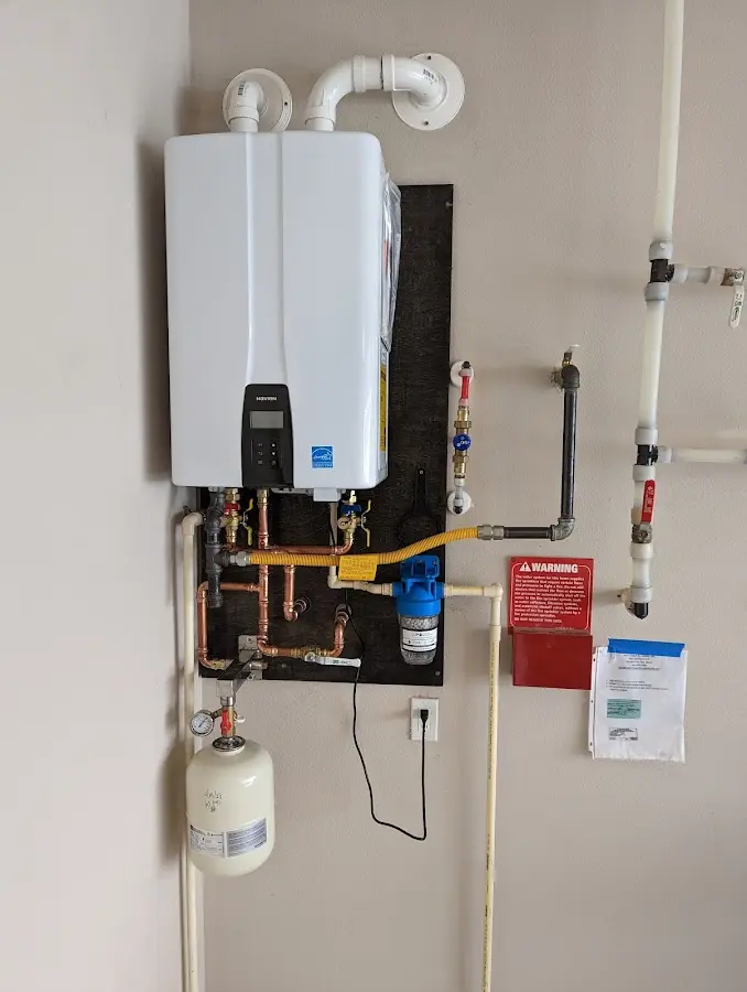 Professional plumber installing copper piping in a Whiteland home